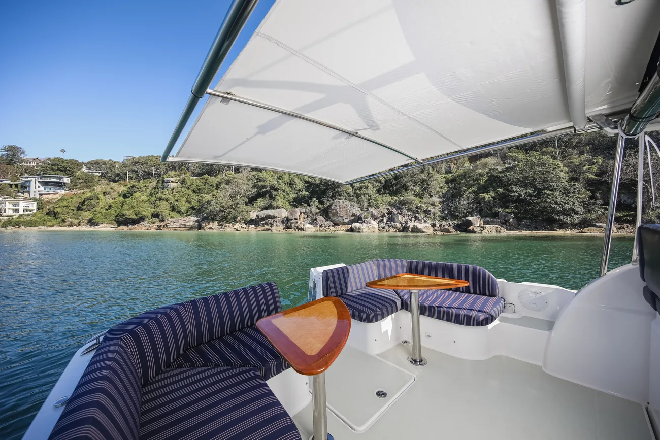 The view from a boat's own cockpit, moored in a calm, green Middle Harbour bay